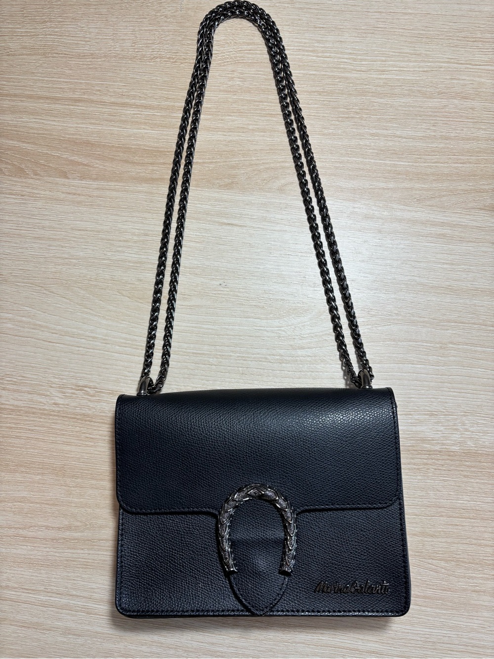 Black Leather Shoulder Bag with Chain Strap and Decorative Horseshoe Accent